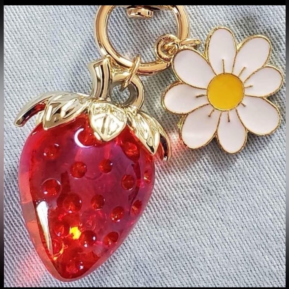 Strawberry bag charm with daisy and heart gold clasp approximately 3.5 inches